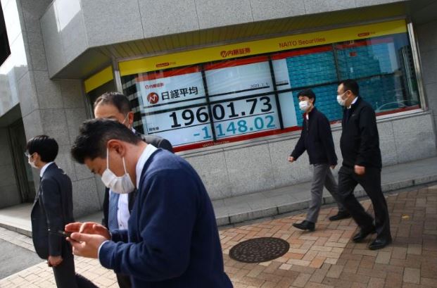شاشة إلكترونية تعرض متوسط المؤشر نيكي للأسهم اليابانية خارج مكتب للسمسرة في العاصمة طوكيو يوم 9 مارس 2020. تصوير: إدجار جاريدو - رويترز.